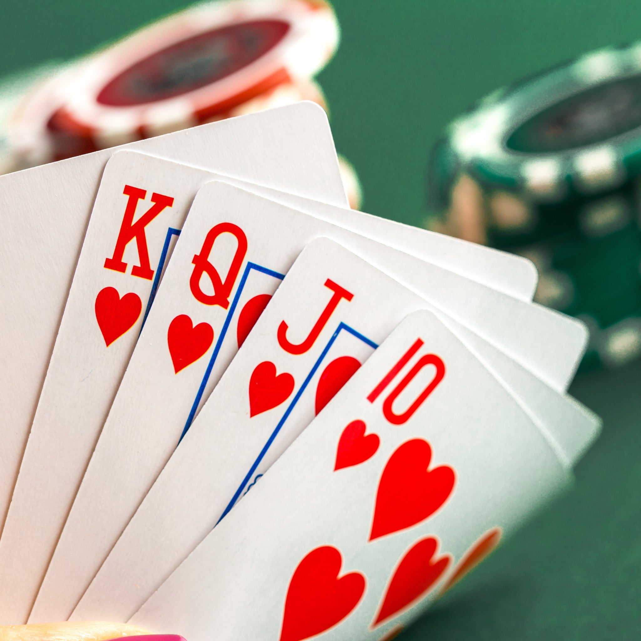 Dealer button and poker card guard on green felt table
