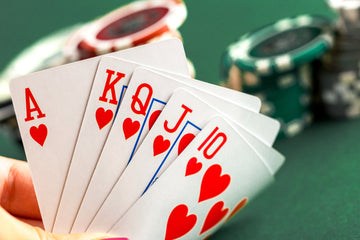 Dealer button and poker card guard on green felt table