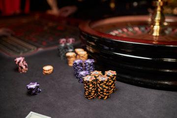 chip values for poker explained with gambling chips and a complete poker playing set on a home table - MRC Poker Store