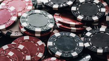 A stacked poker chip set featuring red, black, and green gambling chips, commonly used as casino chips and game chips for home games and poker table setups. | MRC Poker